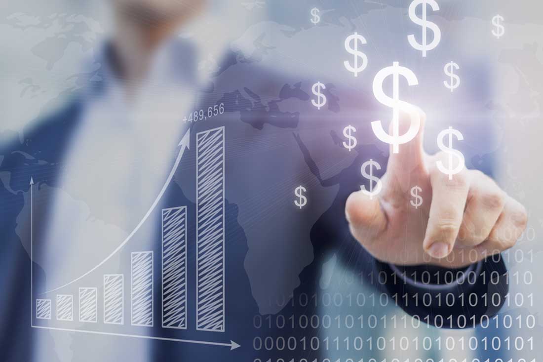 Man touching a dollar sign next to a bar graph that is increasing in growth.